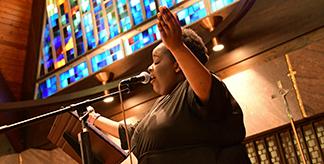 A woman singing in the Chapel of Mercy at Mount Mercy University