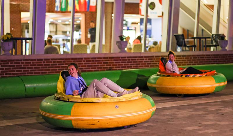 Students enjoying bumper cars during a campus event